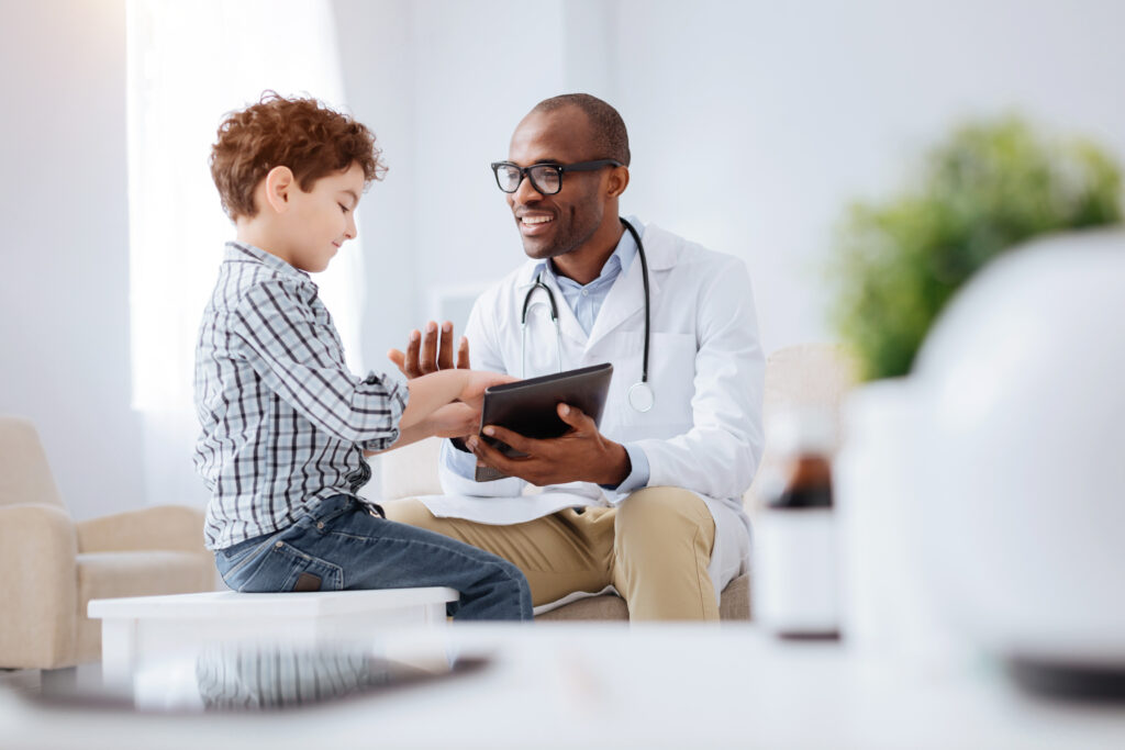 Data,In,Tablet.,Energetic,Cheerful,Male,Doctor,Grinning,While,Showing