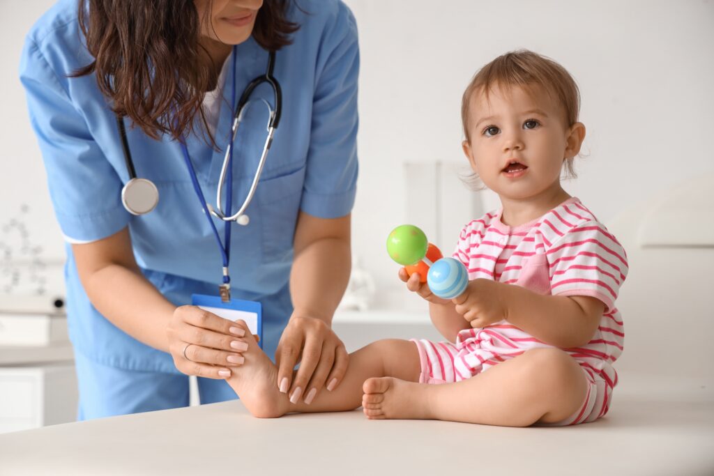 Female,Pediatrician,With,Stethoscope,,Toy,And,Cute,Little,Baby,In